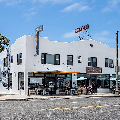 The image shows a white, two-story building with 