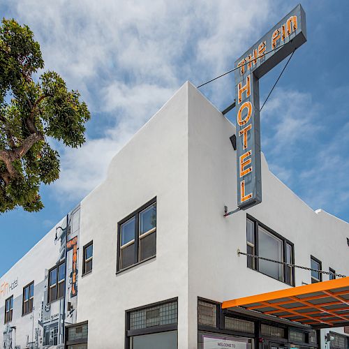 A modern hotel building with a vintage-style sign that says 